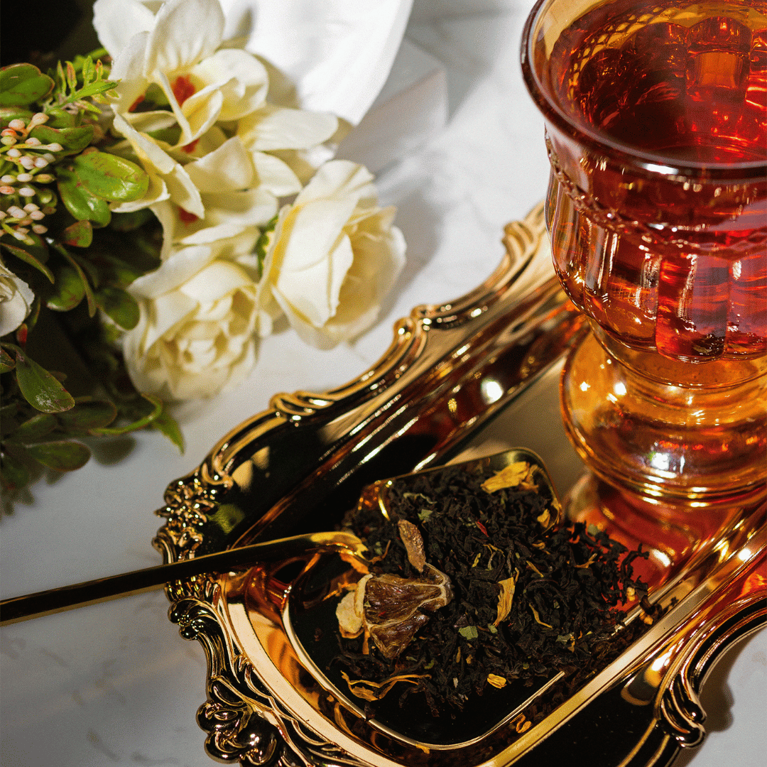 brewed and loose leaf orange chocolate black tea with gold teaspoon